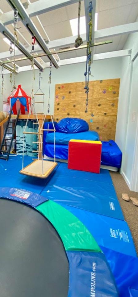 Therapy room with climbing wall and sensory equipment